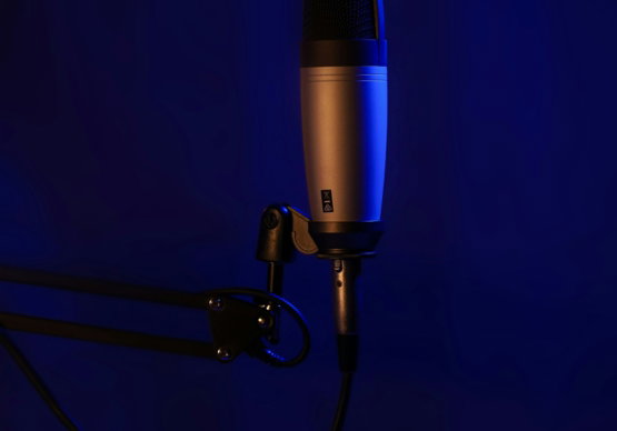 a-microphone-on-a-stand-in-a-dark-room.jpg a microphone on a stand in a dark room